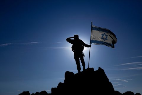 Soldier On Top Of The Mountain With The Israeli Flag